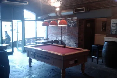 This red pool table has pride of place in one of the four rooms.