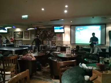 There are some TVs showing sports over here.