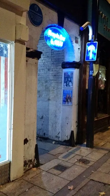 Look for the blue neon sign!