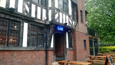 Mock Tudor frontage with traditional mock Tudor neon.